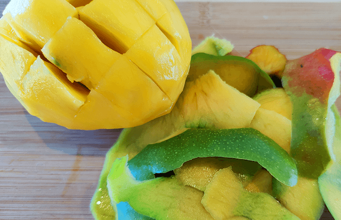 fresh cut mango and mango peels