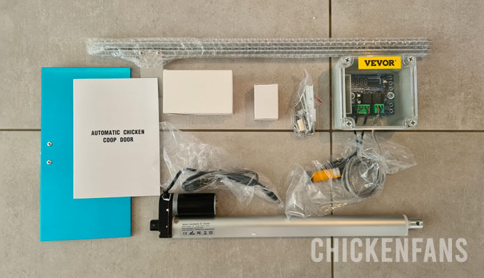 VEVOR automatic chicken coop door unboxing showing all items in the box with the door, rod and controller unit