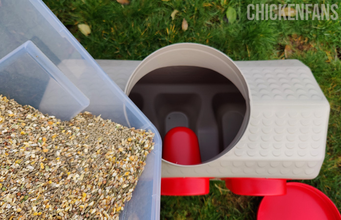 the inside of a overez chicken feeder while feed is distributed in the feeder